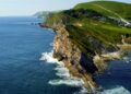 Aerial drone view of the Jurassic Coast in Dorset, England, showing dramatic cliffs, blue sea and coastline – UNESCO World Heritage Site