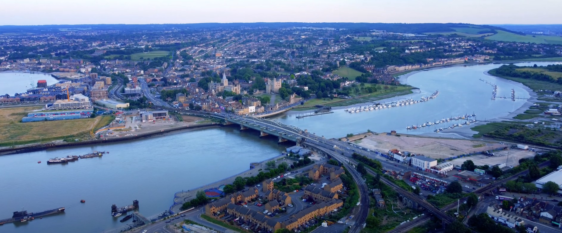 Aerial drone view of Rochester Bridge crossing River Medway with Rochester Castle and Rochester Cathedral in the background, Medway Kent UK